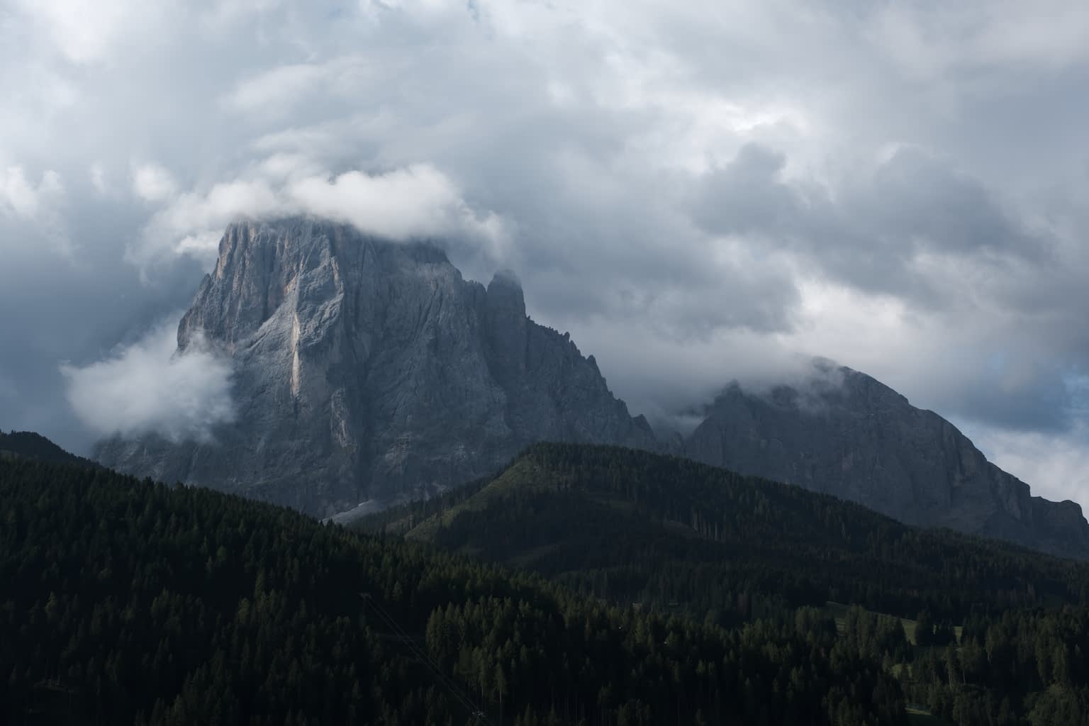 The Langkofel mountain range embedded in a cover of clouds
